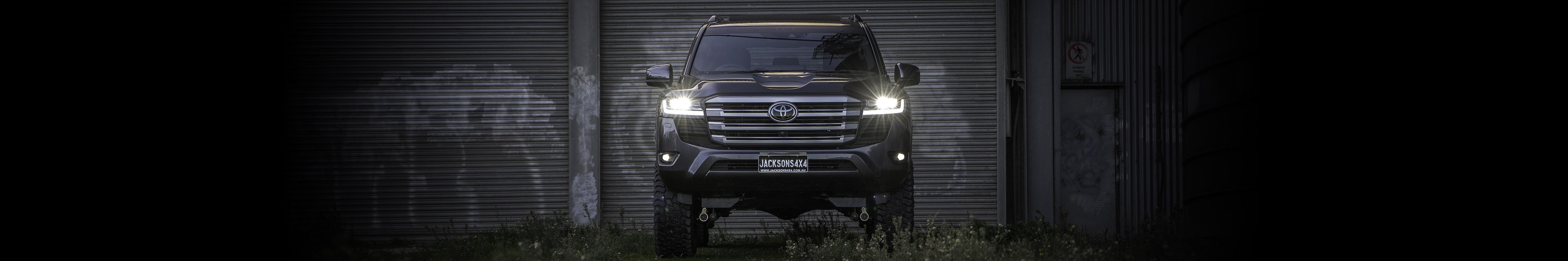 Front view of 300 Series Landcruiser with headlights on
