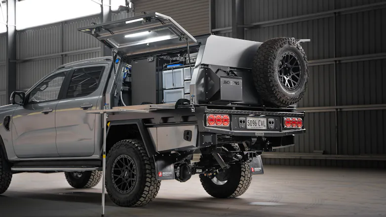 Silver Next-Gen Ford Ranger with Jacksons Australia canopy opened out, showing interior lights