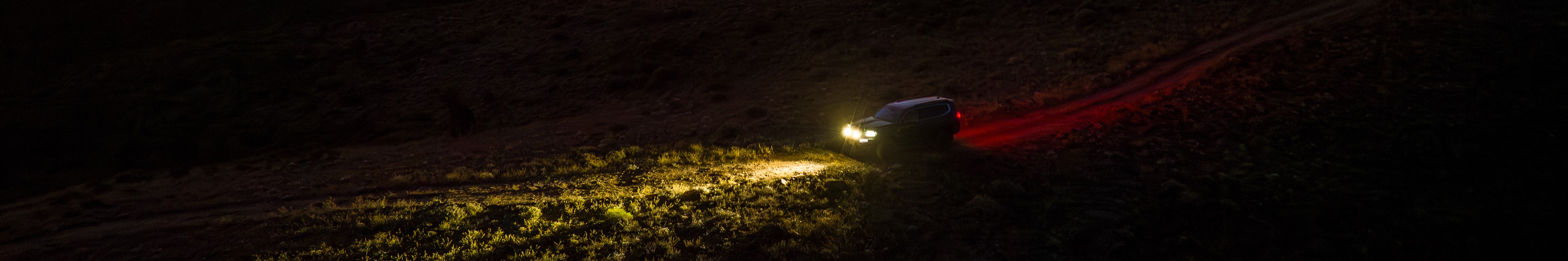 Landcruiser driving offroad at nighttime