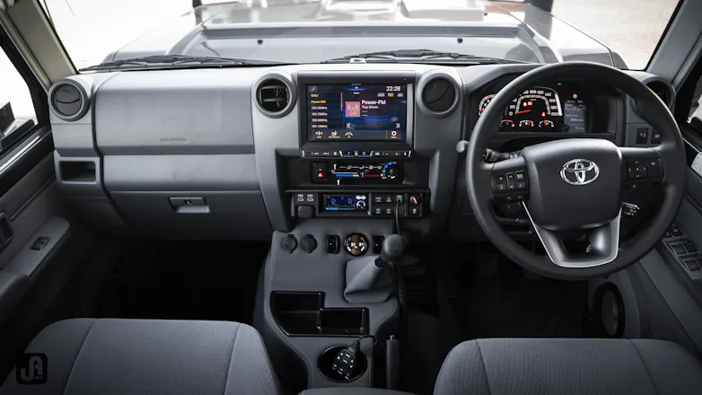 View of front seats and interior controls on dashboard of 2024 Toyota 79 Series Landcruiser