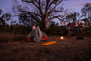 Setting up camp for the night by the fire